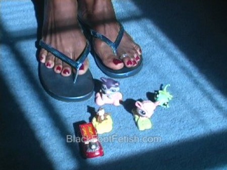 Ebony Giantess Crushing Toys In Flip Flops - We received a request to do a giantess scene crushing toys with feet. We have never done anything like this and figured we would give it a try. Here latonya puts on a pair of blue flip flops then slides them off to step all over the miniture animals and a car toy. If you have any request or any ideas to make these type of scenes any better just drop us an email. Don't worry, we won't spam you or sell our list to anyone else. We just want to hear your request and comments. This clip was recorded and uploaded today. It was a fun clip to make and we hope you will order it today!